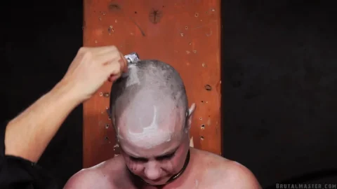 Bald Woman with Tattoos and Nipple Piercings Gets Makeup Applied