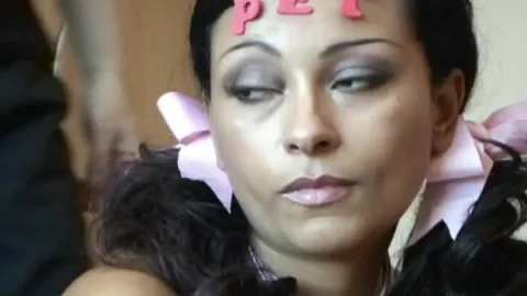 Black girl with bow in hair gives toy blowjob in natural light