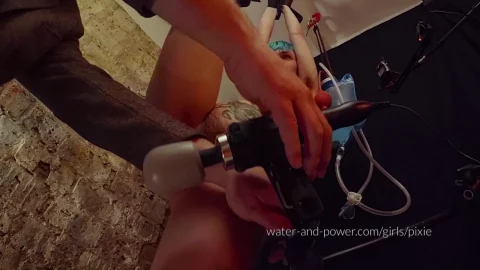 Teal-haired girl in industrial bondage gets equipped