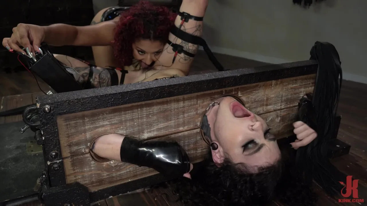 Two white women in BDSM scene with bondage and anal play