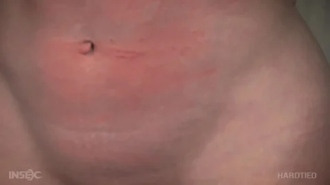 Blonde guy tied up and fisted in dim bondage room