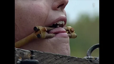 Blonde woman in outdoor bondage and gags