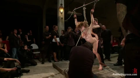 Blonde girls in BDSM club scene with caning and suspension