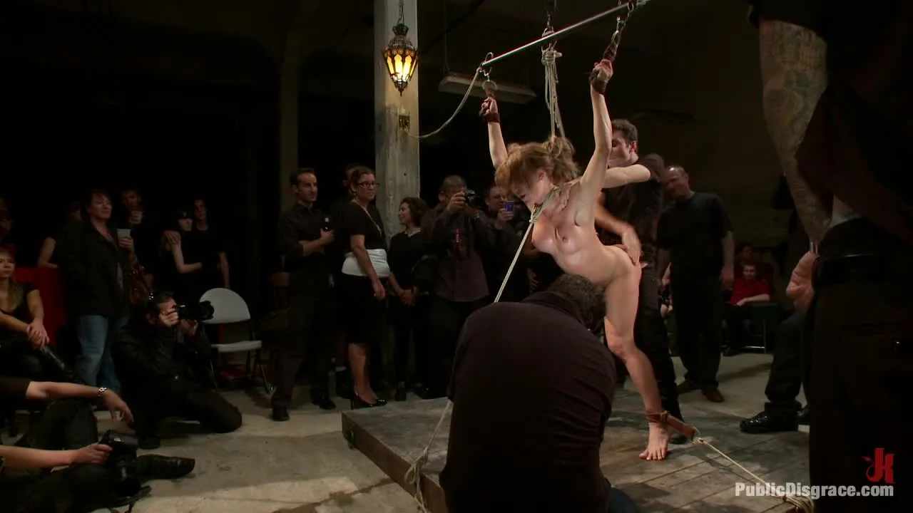 Blonde girls in BDSM club scene with caning and suspension