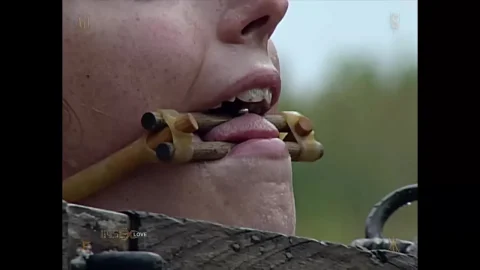 Blonde in bucket gag gets tied up in outdoor field