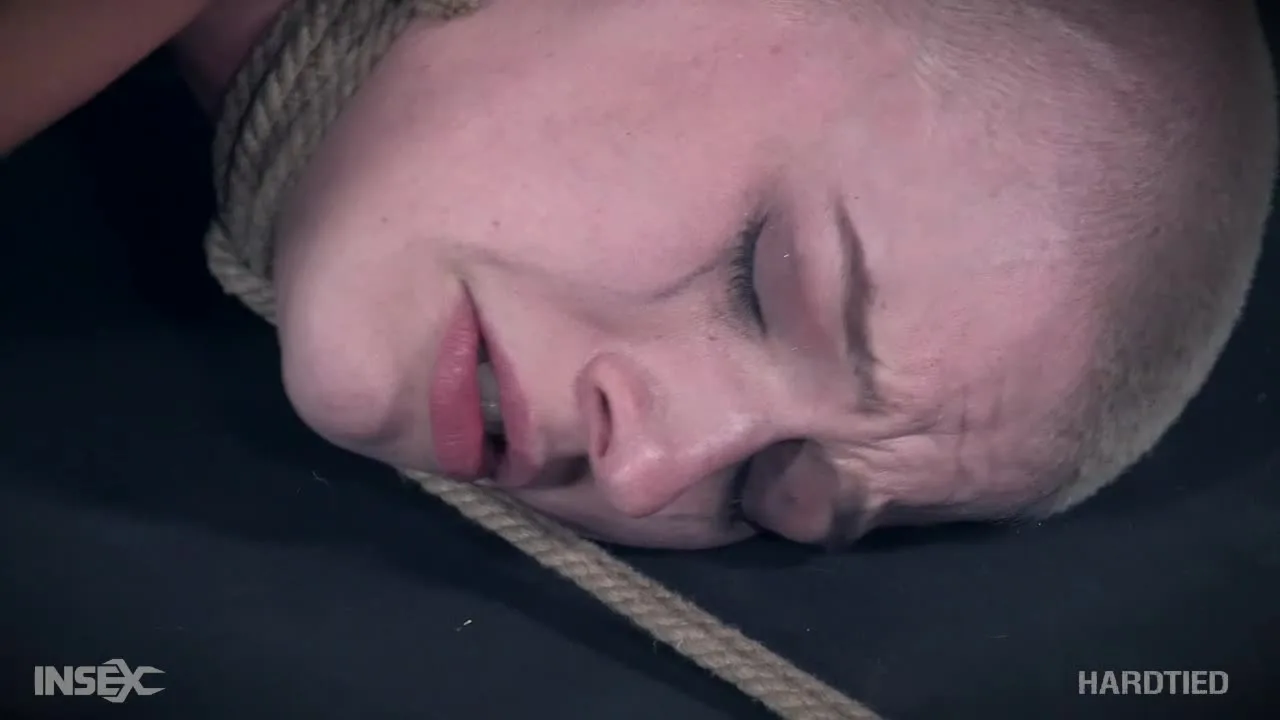 Blonde guy tied up and gagged while another man dominates him with rop