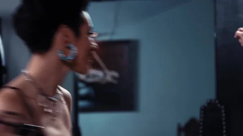 Black-haired woman with tattoos punishes guy on X-frame, gives blowjob