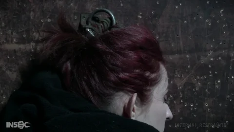 Redhead in handcuffs gets fucked doggy style in concrete room